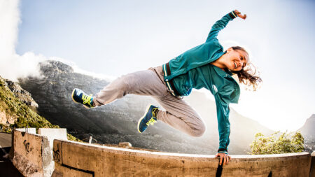 breakdancer-full-of-vitality-jumping-over-a-wall-parkour-style